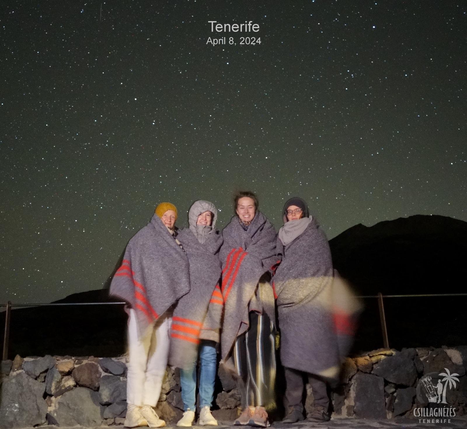 Participants wrapped in blankets under a starry sky in Tenerife