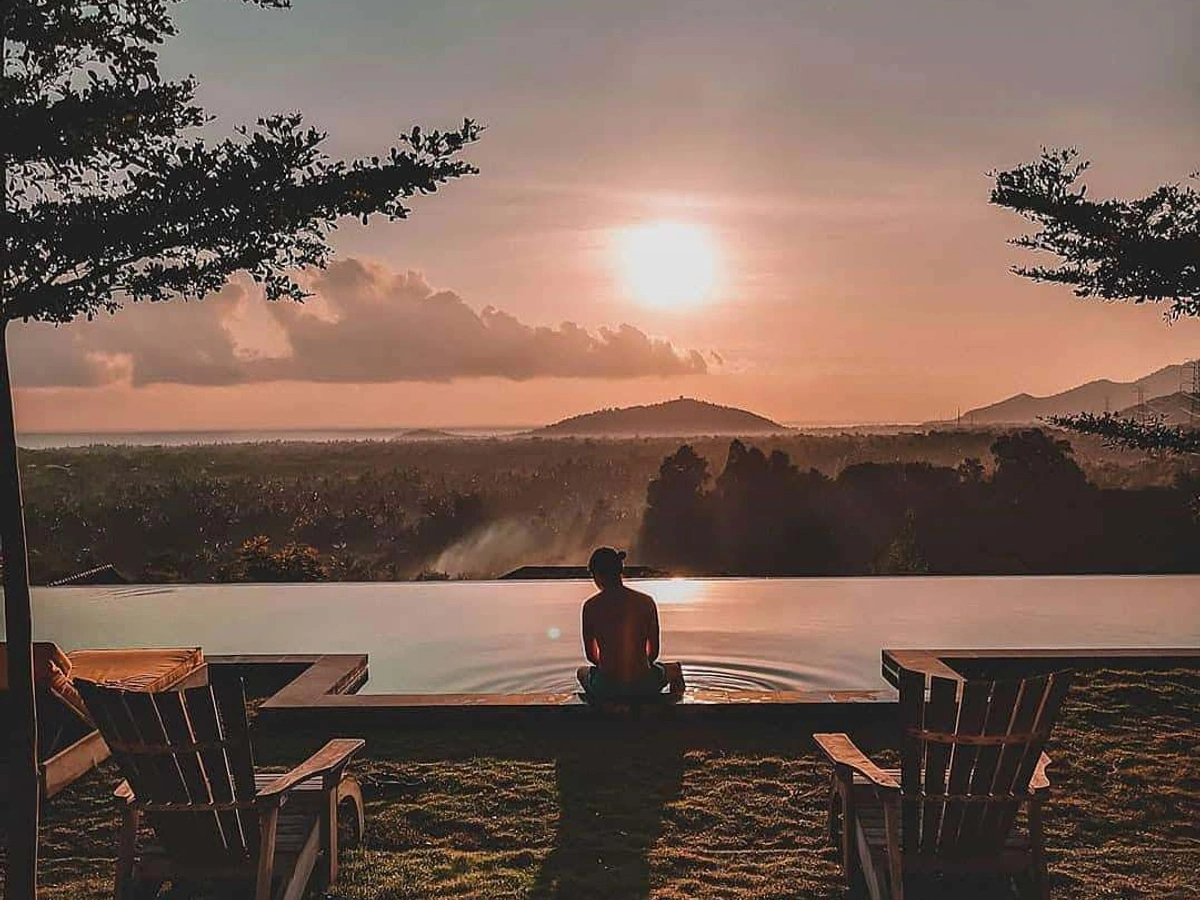 Sunset meditation at an infinity pool overlooking northern Bali